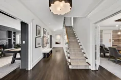 طراحی داخلی معاصر.  سرسرا  کف چوب تیره  دیوارهای خاکستری روشن  تر و تمیز سفید  دونده پله.