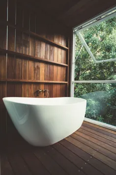 وان در یک حمام چوبی آرام از یک خانه ساحلی مدرنیست دهه 70 بازسازی شده با منظره جنگل بارانی نیمه گرمسیری Shire of Noosa ، Sunshine Coast ، Queensland ، Australia [2000 13 1319]