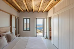 دیوارهای سنگی منحنی باعث می شوند خانه تعطیلات Xerolithi با منظره جزیره یونان ادغام شود