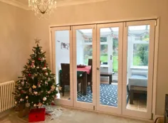 درهای دو شاخه داخلی به رنگ سفید در کنار درخت کریسمس