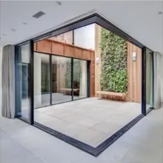 گوشه ای درهای شیشه ای کشویی باز شده در یک آپارتمان لوکس در لندن